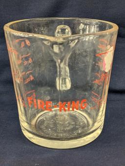 Set of 2 Fire King glass measuring cups include a 1 cup and 2 cup; larger measures 5" tall.