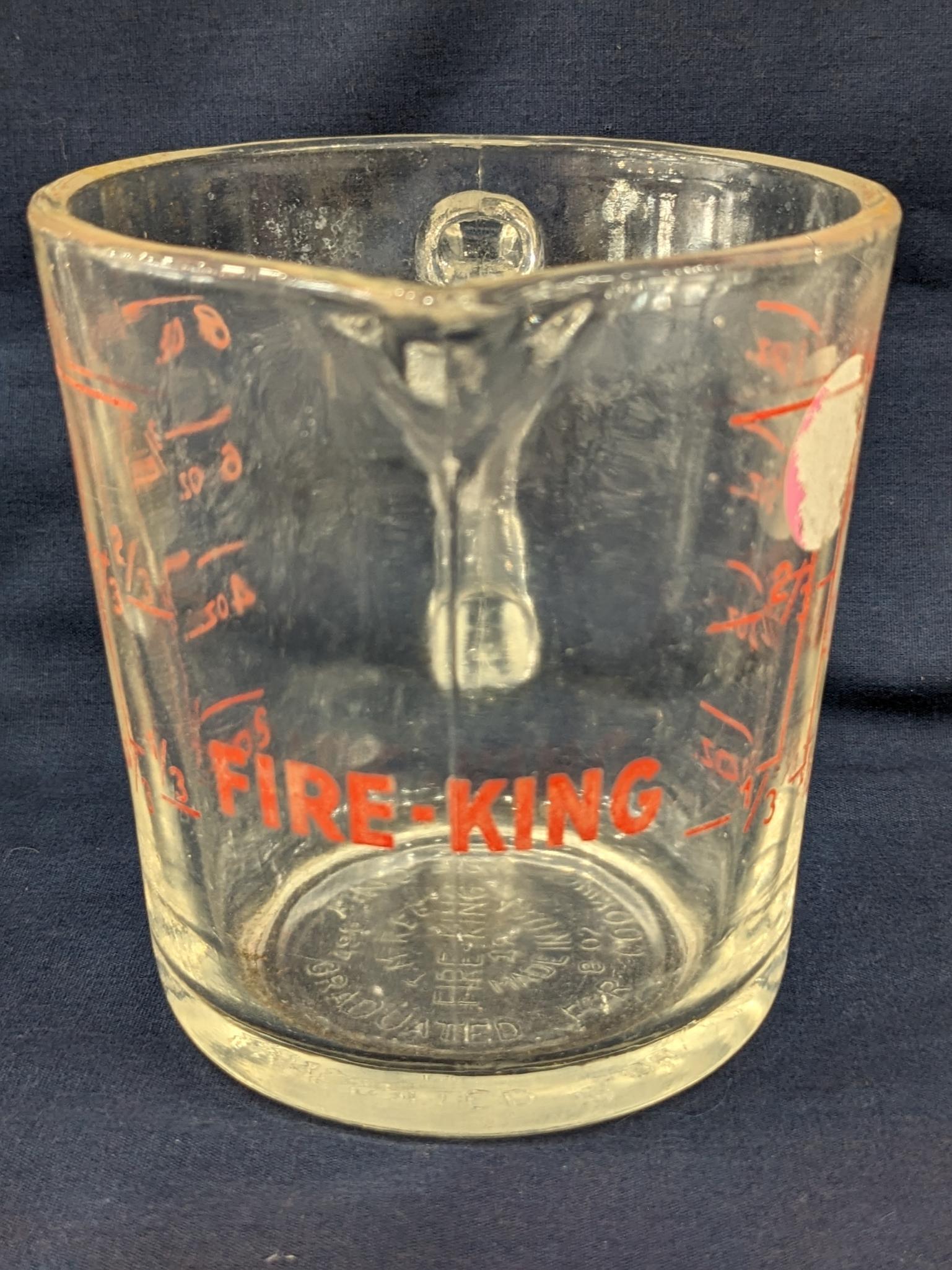 Set of 2 Fire King glass measuring cups include a 1 cup and 2 cup; larger measures 5" tall.