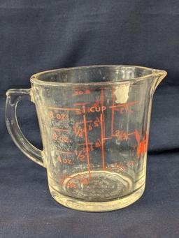 Set of 2 Fire King glass measuring cups include a 1 cup and 2 cup; larger measures 5" tall.