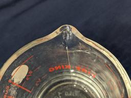 Set of 2 Fire King glass measuring cups include a 1 cup and 2 cup; larger measures 5" tall.