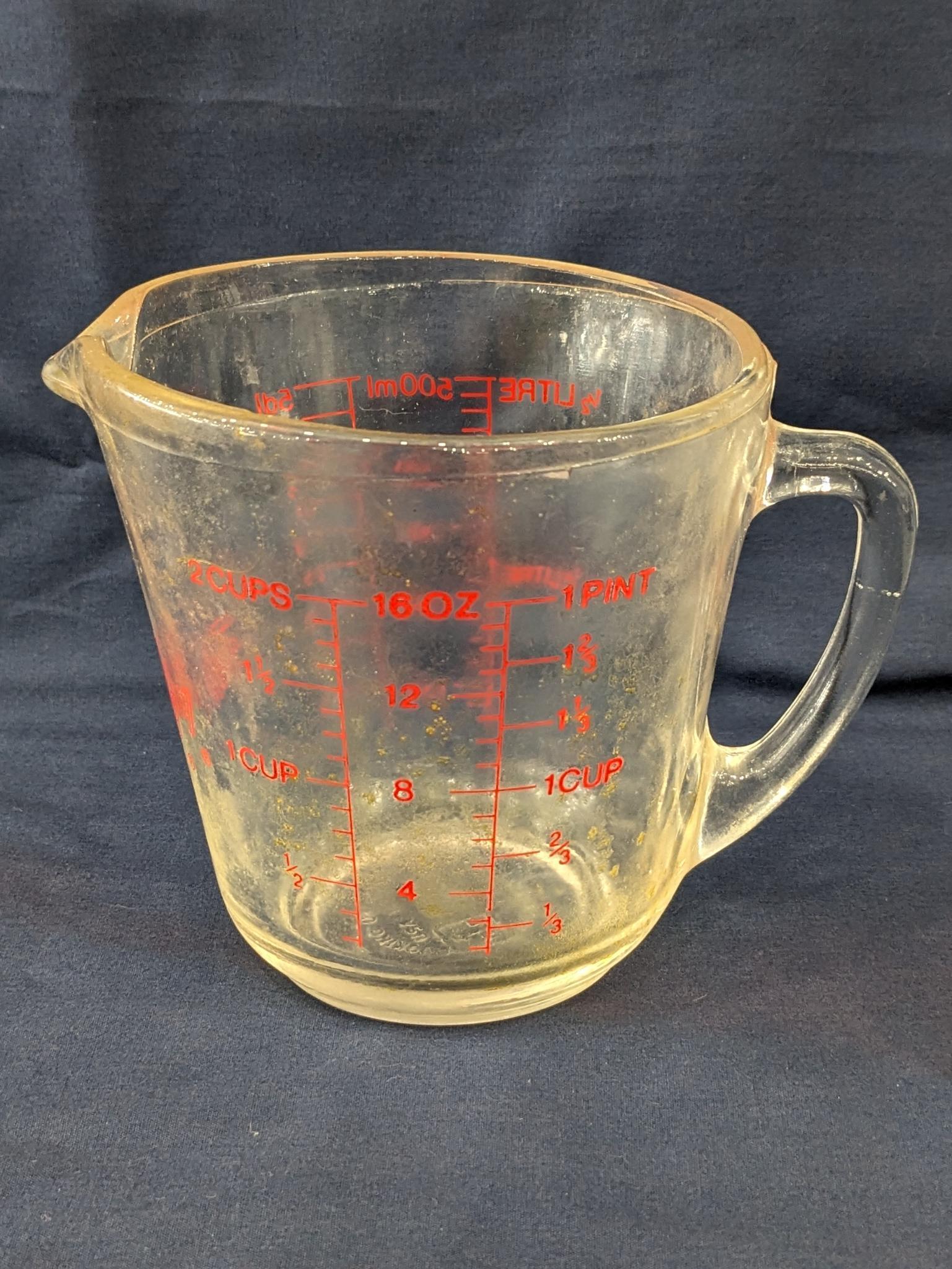 Set of 2 Fire King glass measuring cups include a 1 cup and 2 cup; larger measures 5" tall.