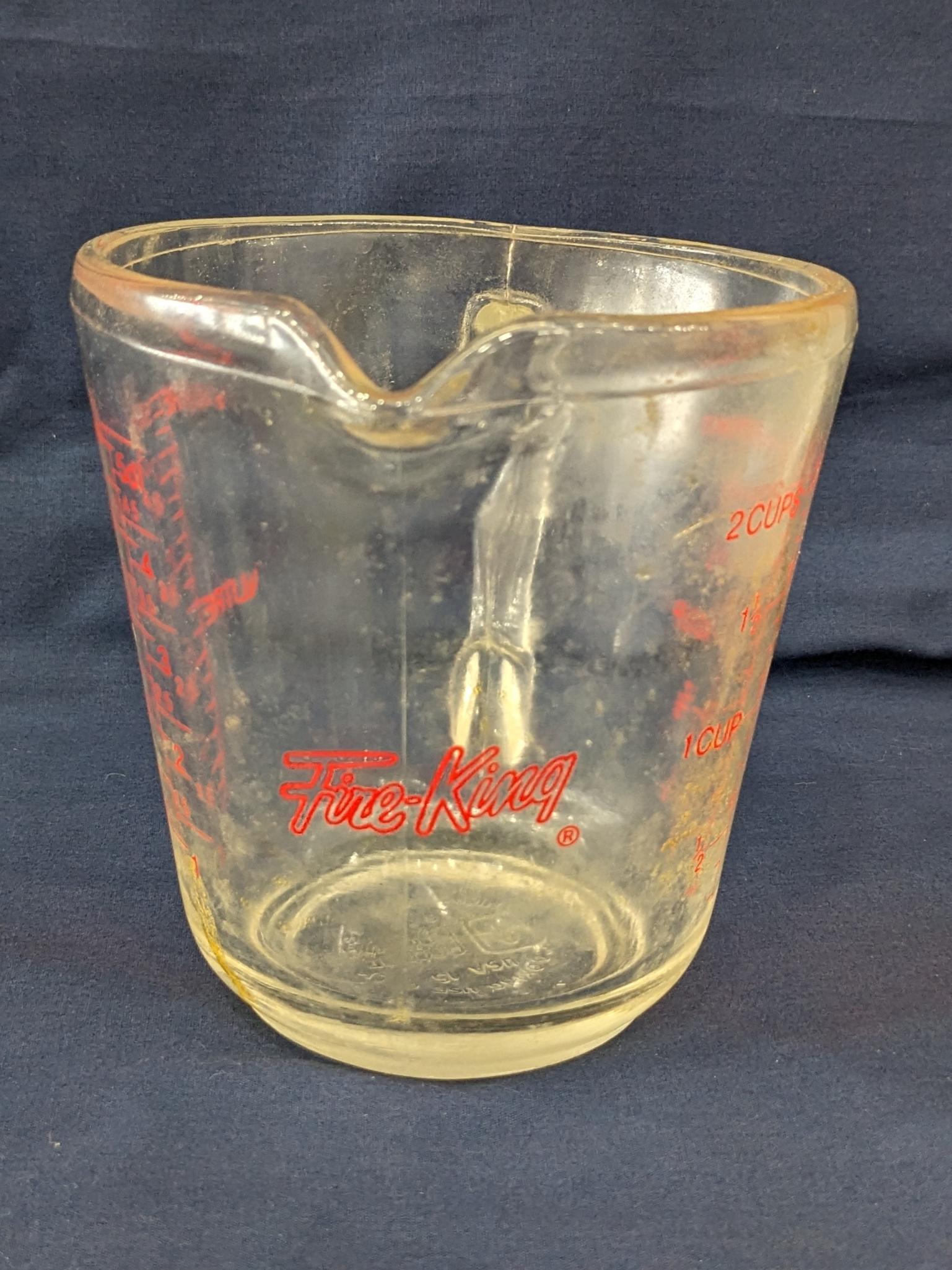 Set of 2 Fire King glass measuring cups include a 1 cup and 2 cup; larger measures 5" tall.