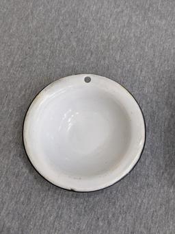 Two enamelware bowls; larger bowl measures 6" x 3". Smaller bowl has a beautiful blue and white