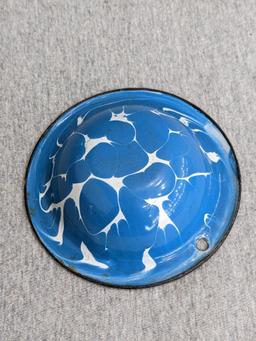 Two enamelware bowls; larger bowl measures 6" x 3". Smaller bowl has a beautiful blue and white