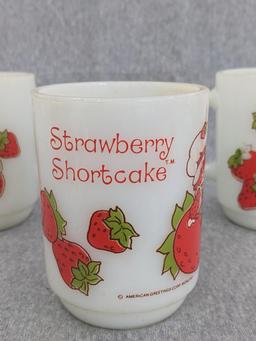Three old Strawberry Shortcake mugs were made by Anchor Hocking. A couple chips noted on one rim and