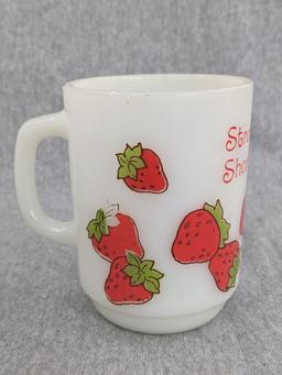 Three old Strawberry Shortcake mugs were made by Anchor Hocking. A couple chips noted on one rim and