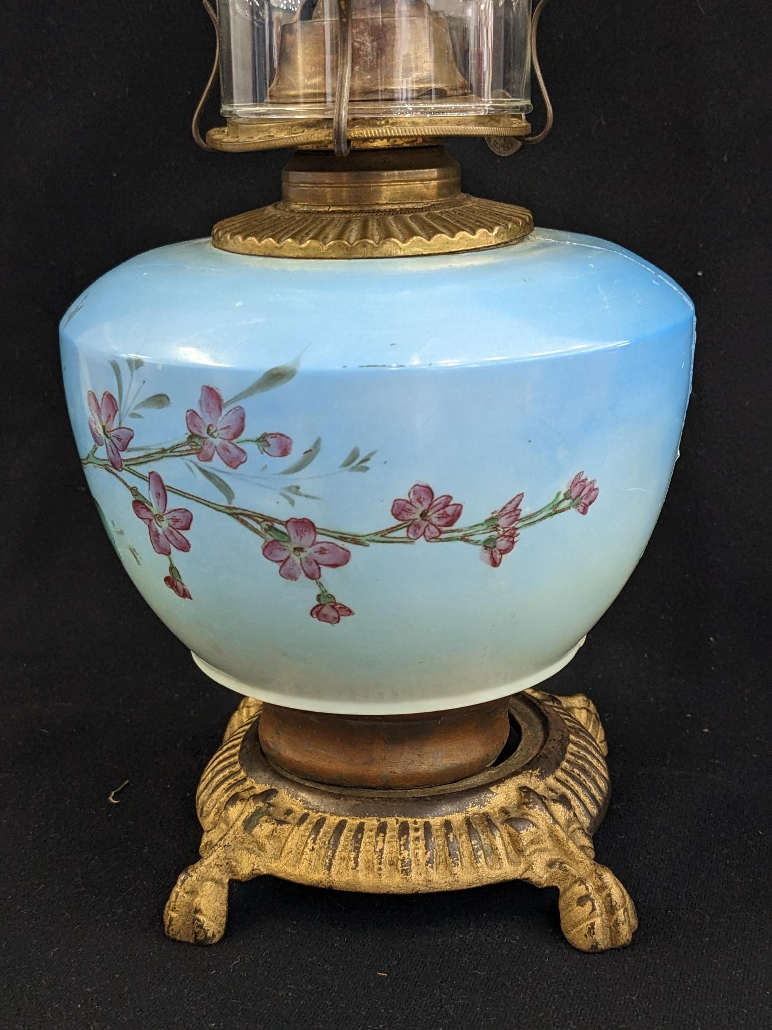 Pretty parlor oil lamp is 17" over chimney and has Eagle burner. For decoration only, notable chips