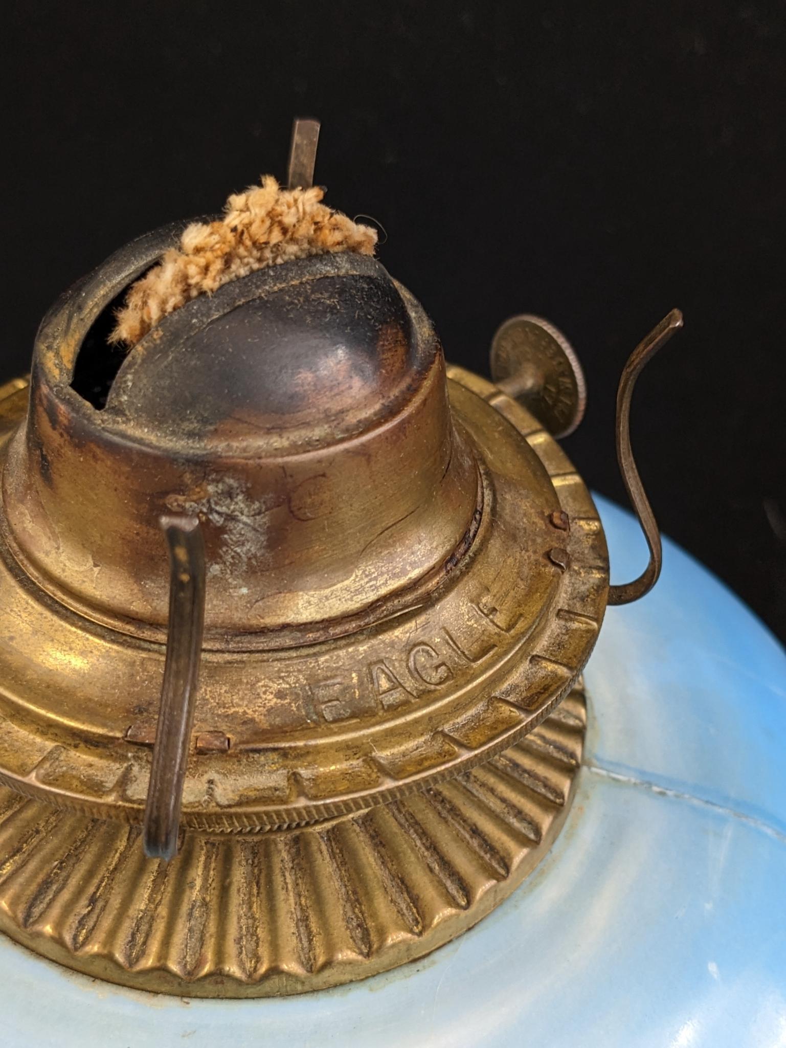 Pretty parlor oil lamp is 17" over chimney and has Eagle burner. For decoration only, notable chips