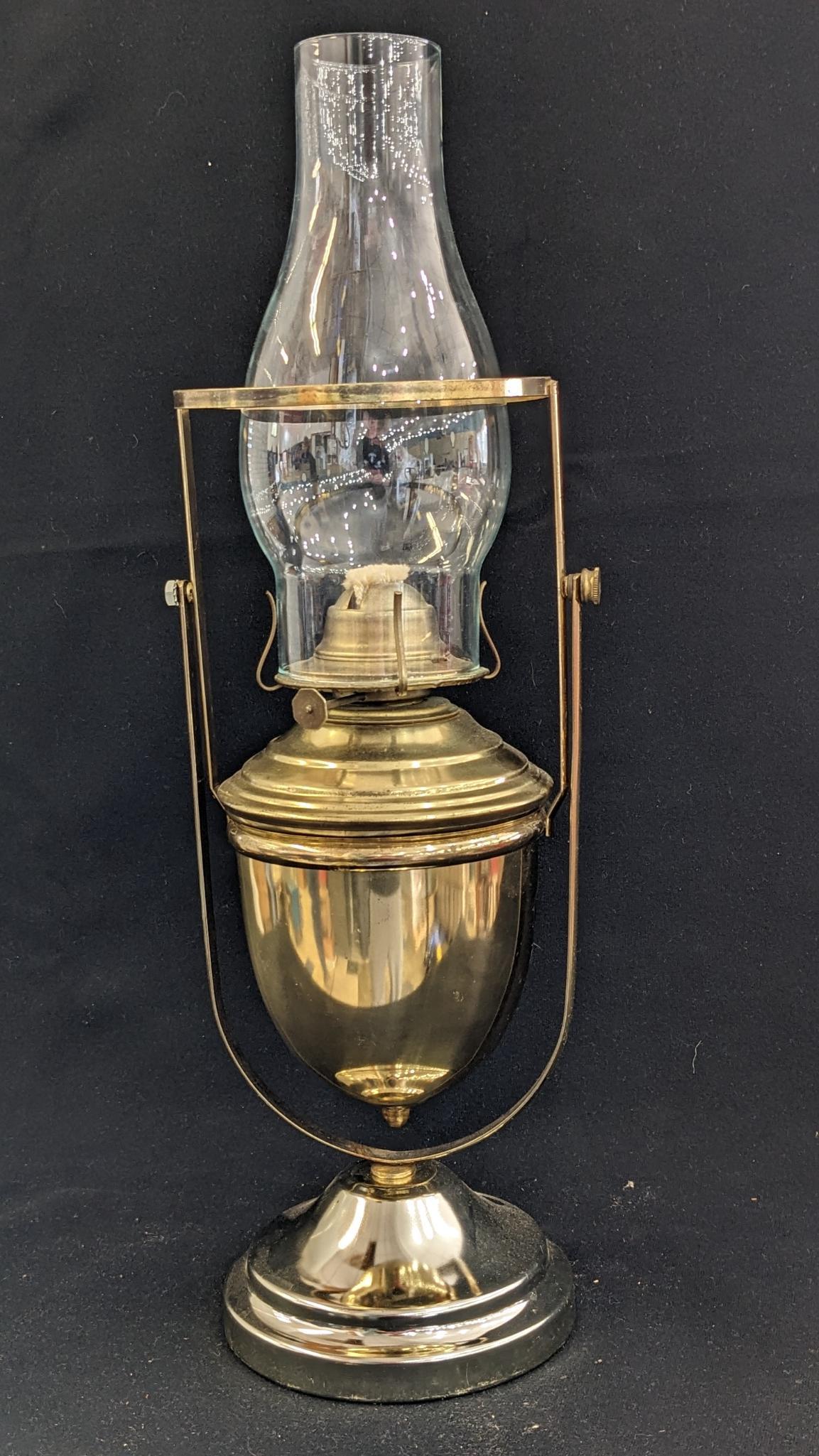 Neat swinging oil lamp has an Eagle burner and stands nearly 19". Chimney in good condition, some