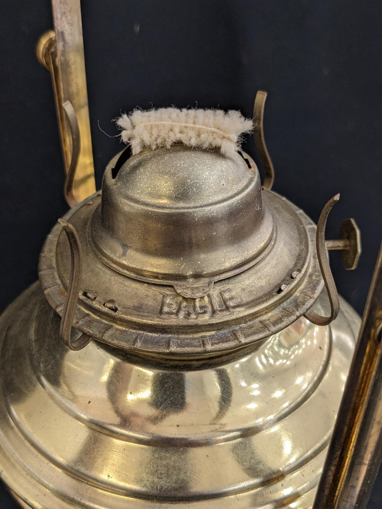 Neat swinging oil lamp has an Eagle burner and stands nearly 19". Chimney in good condition, some