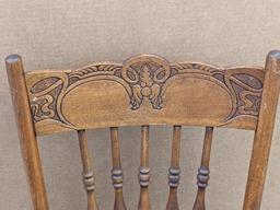 Nice sturdy wooden chair with ornate carving in the back, and a wicker seat. The chair is in overall