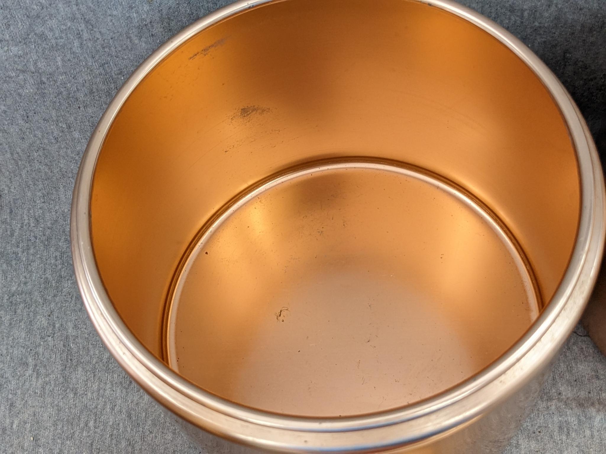 Set of Mirro rose gold canisters. Up to 4 qts. Knobs a little worn but canisters in good condition.