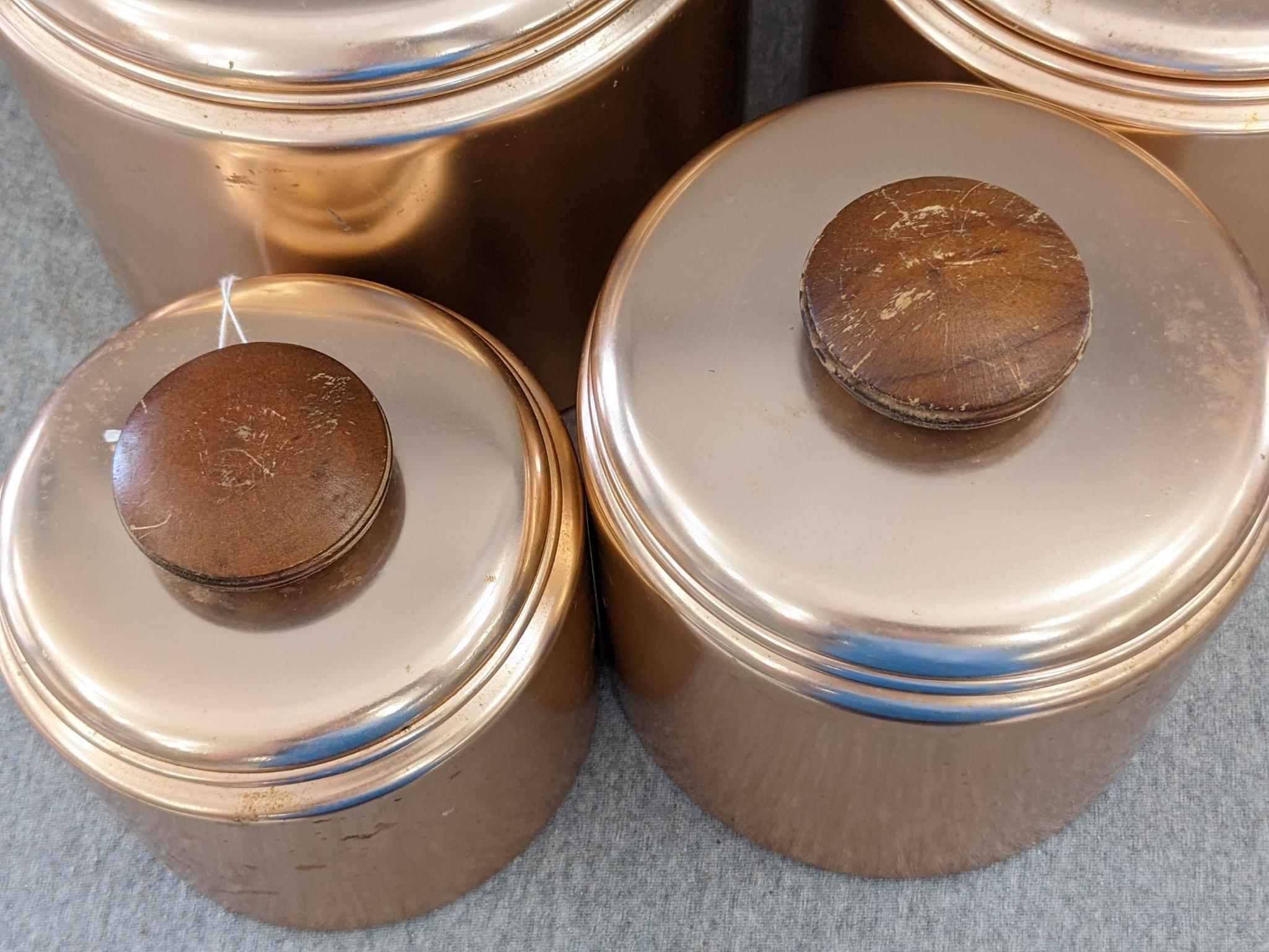 Set of Mirro rose gold canisters. Up to 4 qts. Knobs a little worn but canisters in good condition.
