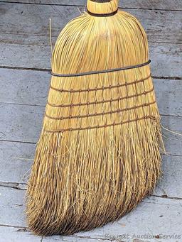 Sturdy corn broom has a wooden handle.