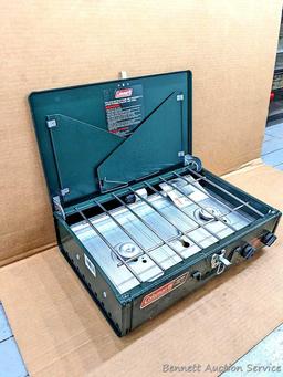 Coleman two burner propane camp stove is 18" x 12" x 5" and comes with original box.