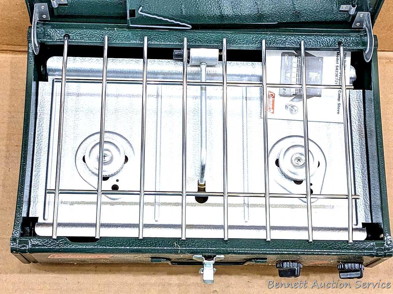 Coleman two burner propane camp stove is 18" x 12" x 5" and comes with original box.
