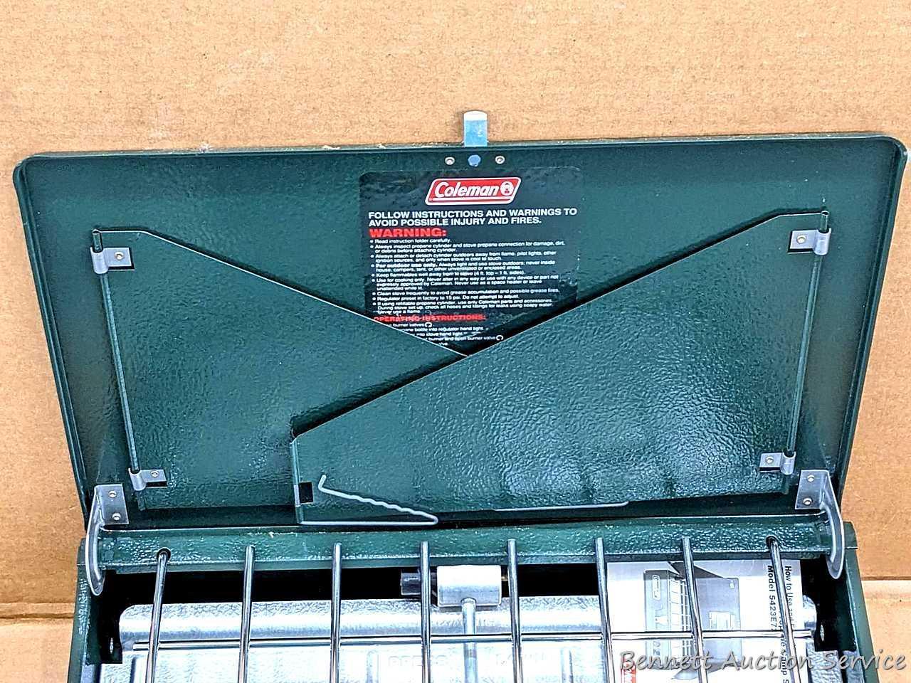 Coleman two burner propane camp stove is 18" x 12" x 5" and comes with original box.