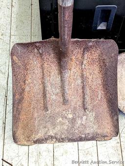 Yard and garden tools including spade shovel, flat bottom shovel, steel leaf rake and a potato fork.