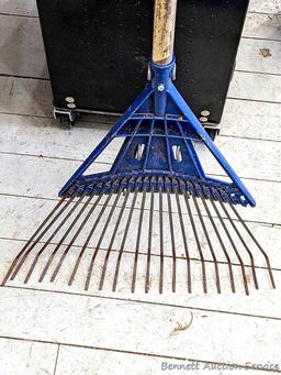 Yard and garden tools including spade shovel, flat bottom shovel, steel leaf rake and a potato fork.