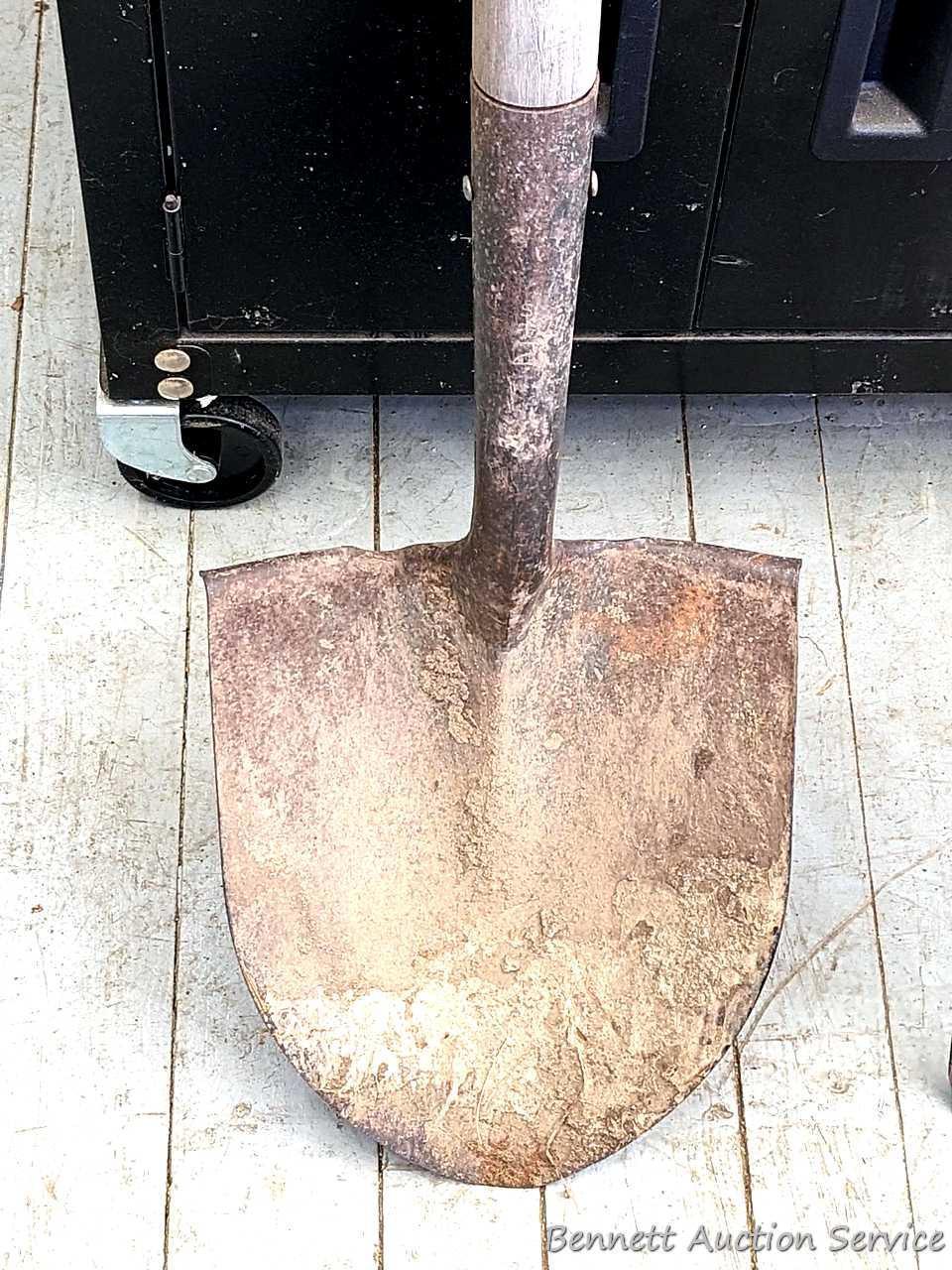Yard and garden tools including spade shovel, flat bottom shovel, steel leaf rake and a potato fork.