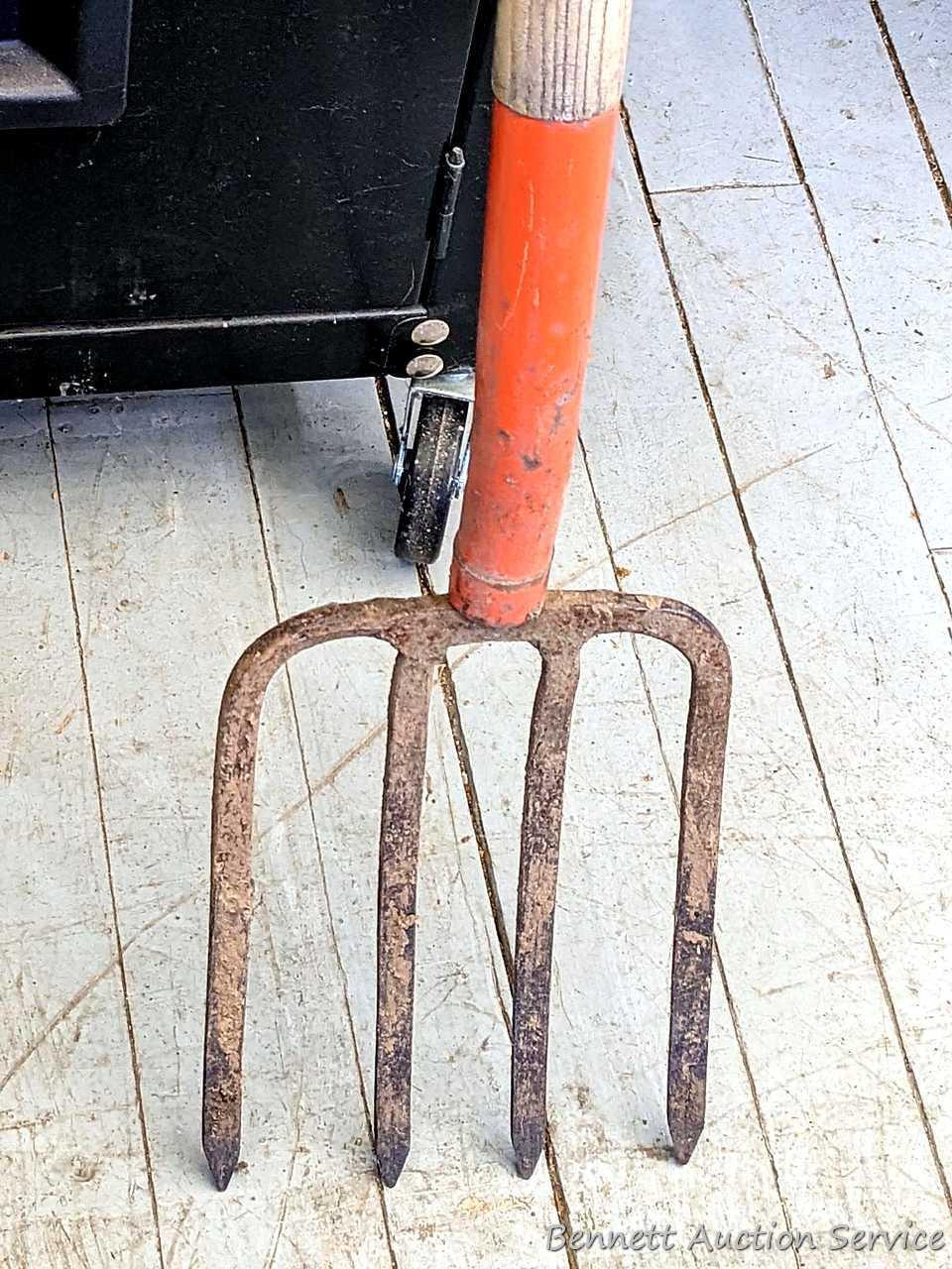 Yard and garden tools including spade shovel, flat bottom shovel, steel leaf rake and a potato fork.