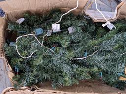 Two artificial Christmas trees, one is strung with lights and the other isn't, unchecked if