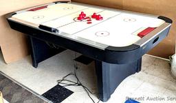 Harvard air hockey game table. Works! Measures 7' x 4' x 32" high and comes with discs and paddles.