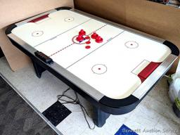 Harvard air hockey game table. Works! Measures 7' x 4' x 32" high and comes with discs and paddles.