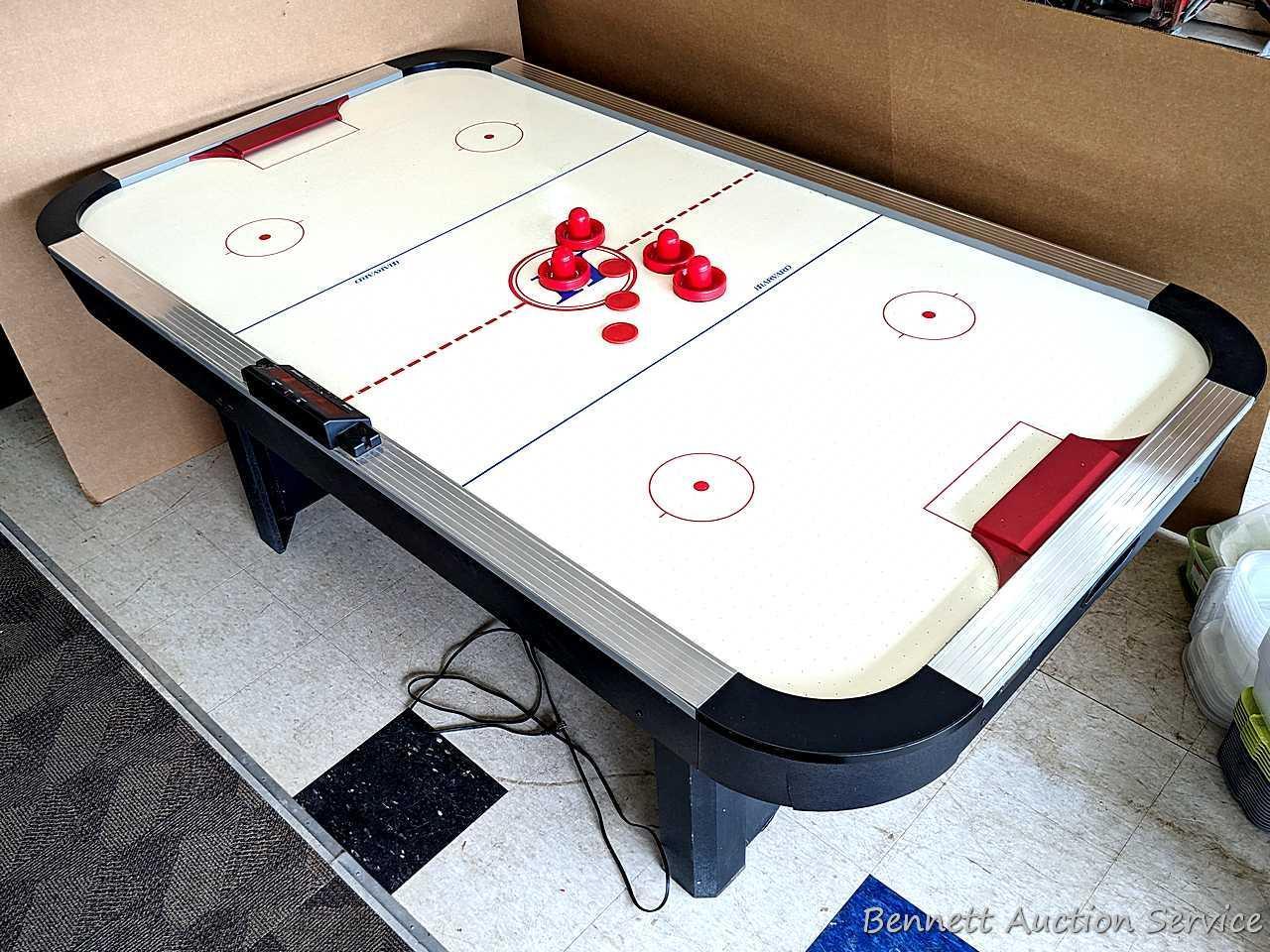 Harvard air hockey game table. Works! Measures 7' x 4' x 32" high and comes with discs and paddles.