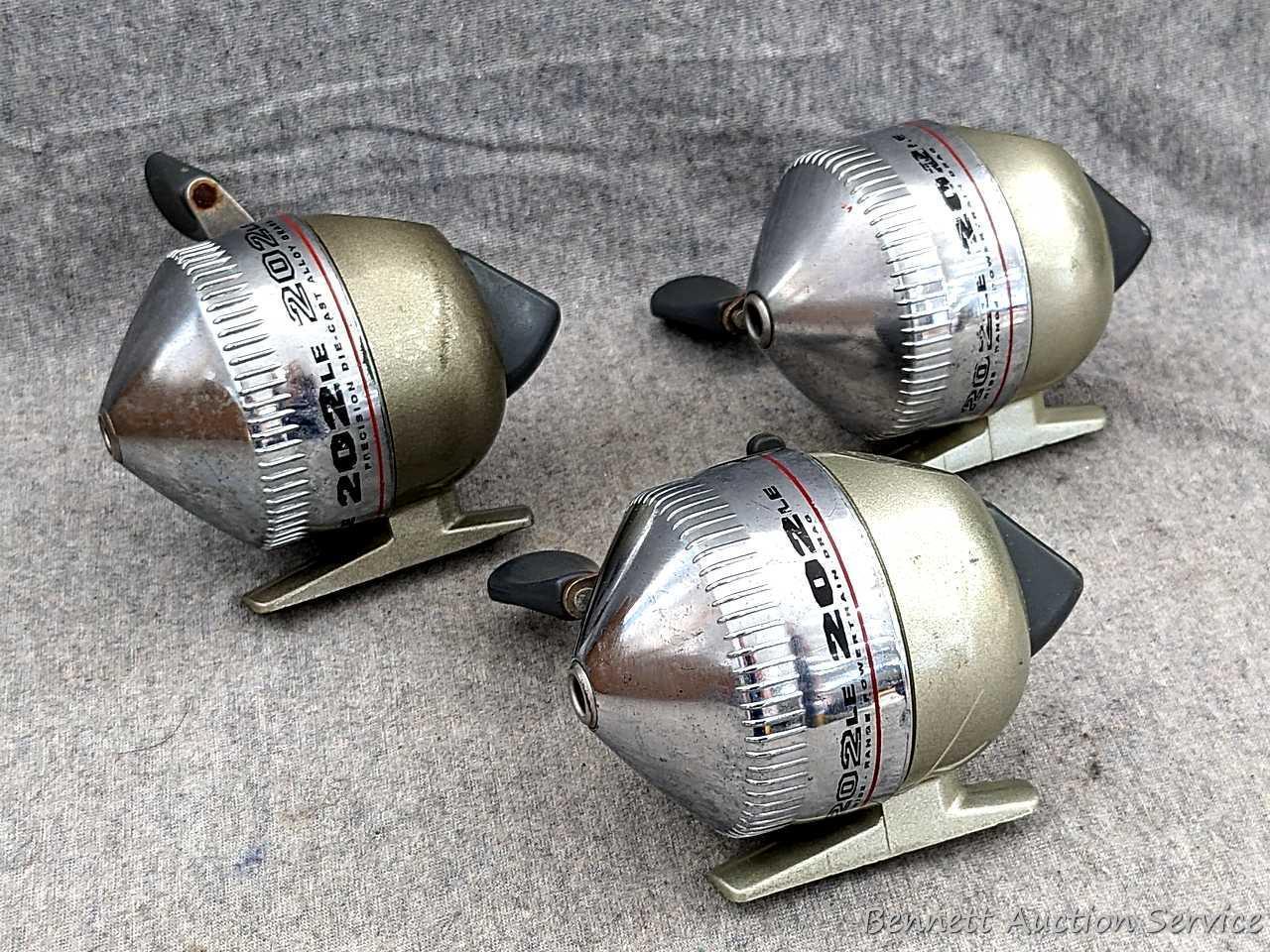3 Zebco 202LE fishing reels. 2 handles spin, one does not spin as smoothly. All about 3-3/4" tall
