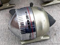 3 Zebco 202LE fishing reels. 2 handles spin, one does not spin as smoothly. All about 3-3/4" tall