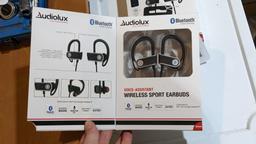 Two AudioLux wireless sport earbuds with voice assistant. Appear unused.
