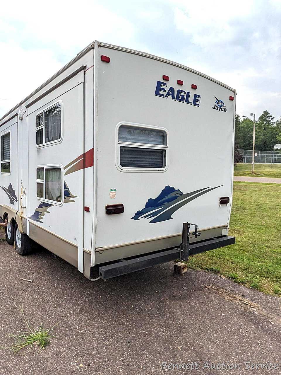 Jayco Eagle 314 BHDS slide-out camper has three beds, bathroom with shower...