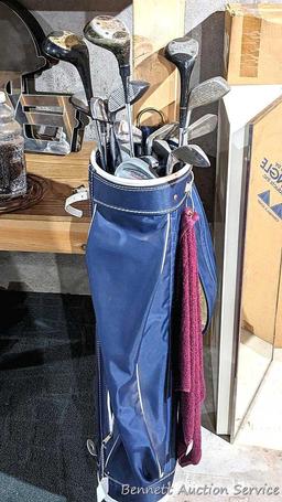Golf clubs incl Wilson and other in a 34" golf bag with contents incl balls and more. Tallest in bag