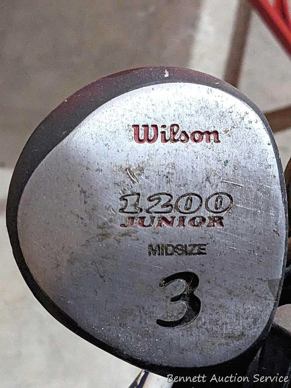 Golf clubs incl Wilson and other in a 34" golf bag with contents incl balls and more. Tallest in bag