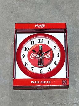 Nice Coca-Cola folding chair about 23" over wooden arms, plus a clock and phone that look new.