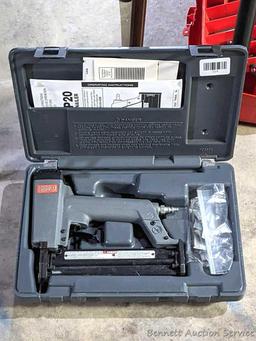 Senco pneumatic nailer with case and manual.