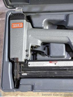 Senco pneumatic nailer with case and manual.