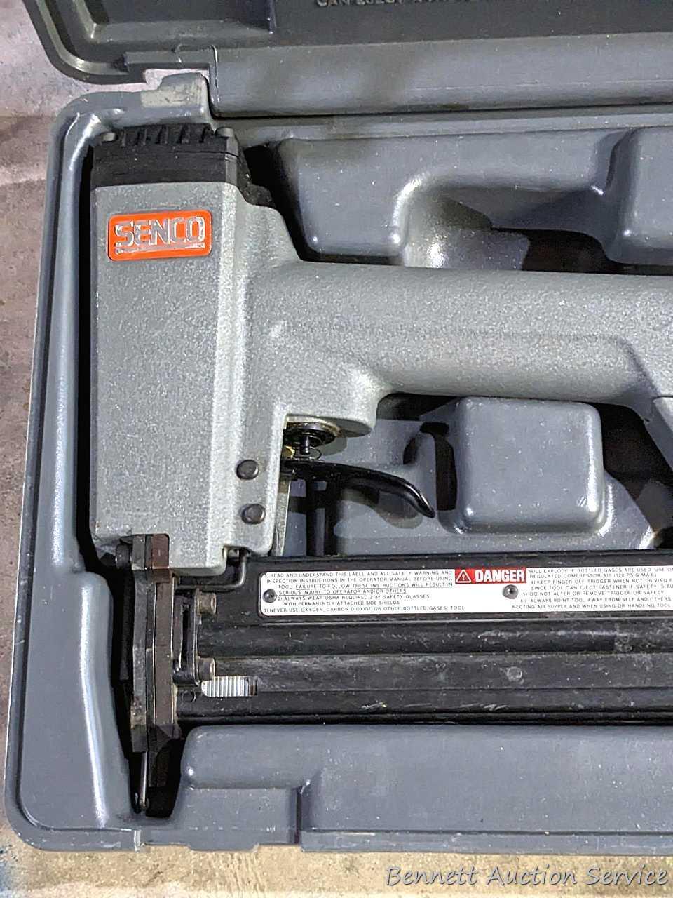 Senco pneumatic nailer with case and manual.