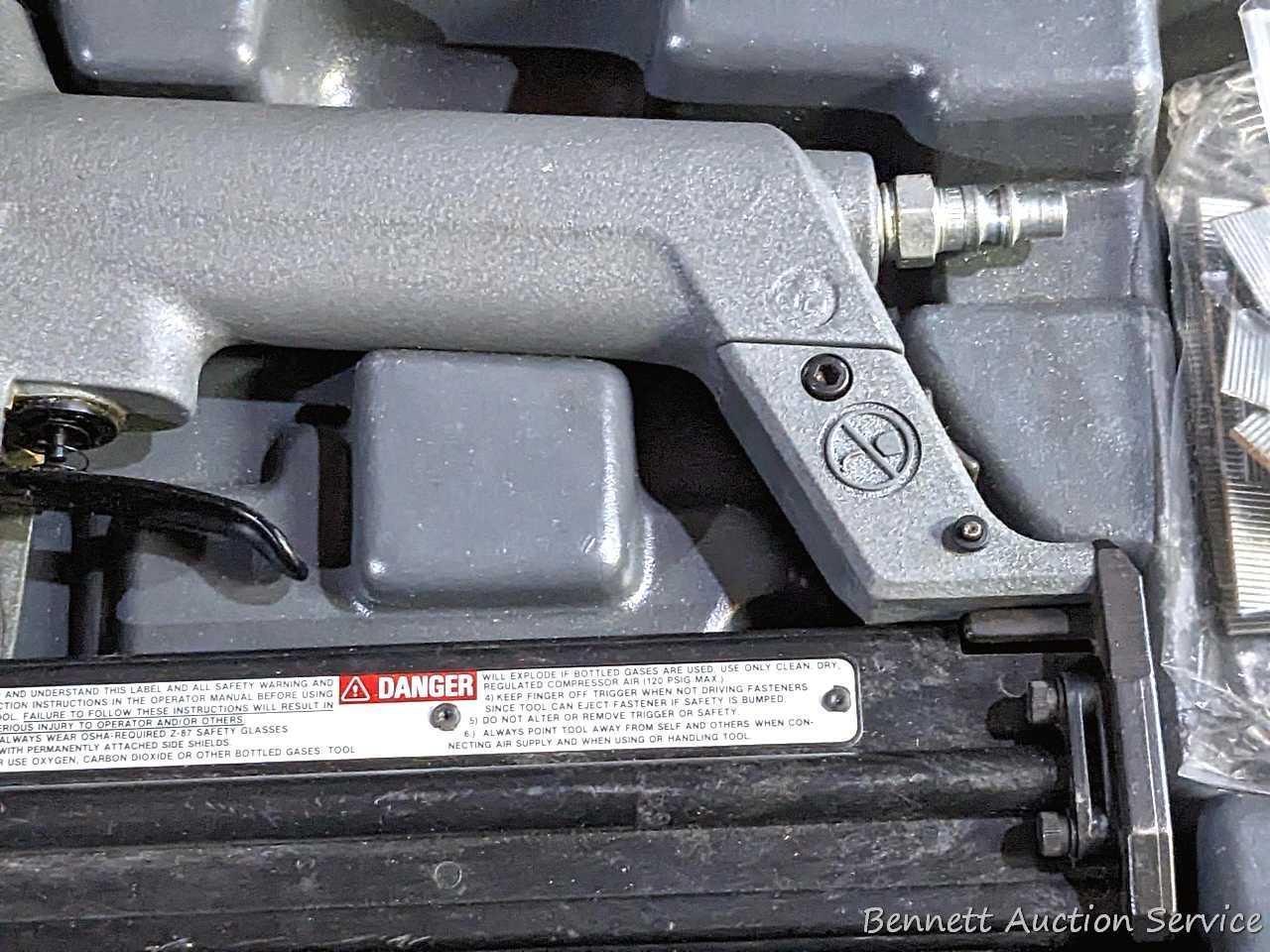 Senco pneumatic nailer with case and manual.