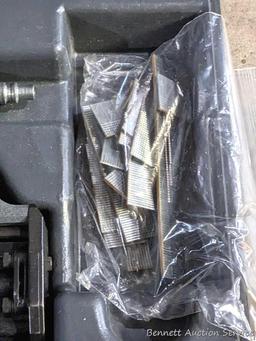 Senco pneumatic nailer with case and manual.