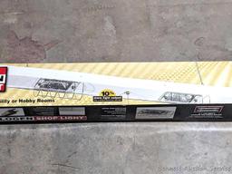 300 watt halogen shop light is new in box - great for garage or workshop.