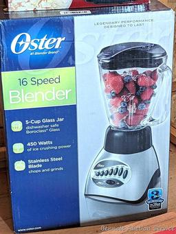 Oster 16 speed blender looks to be NIB, Air Crazy popcorn popper, and a pair of ice cube trays.