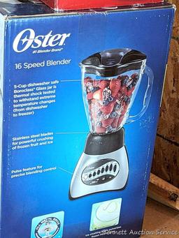 Oster 16 speed blender looks to be NIB, Air Crazy popcorn popper, and a pair of ice cube trays.