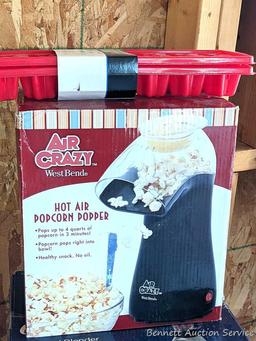 Oster 16 speed blender looks to be NIB, Air Crazy popcorn popper, and a pair of ice cube trays.