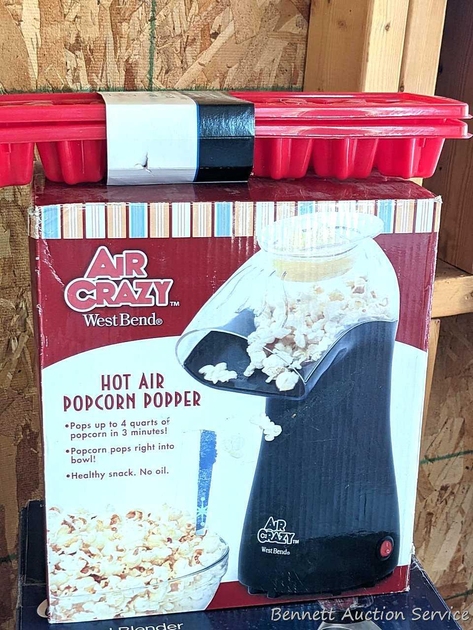 Oster 16 speed blender looks to be NIB, Air Crazy popcorn popper, and a pair of ice cube trays.