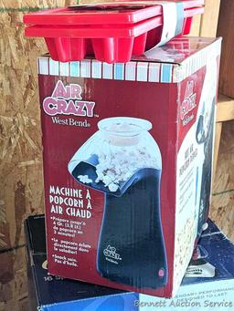 Oster 16 speed blender looks to be NIB, Air Crazy popcorn popper, and a pair of ice cube trays.