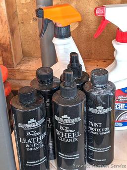 Full and partial bottles of automotive cleaners including leather cleaner, scratch out, tire white,