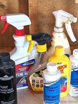 Full and partial bottles of automotive cleaners including leather cleaner, scratch out, tire white,