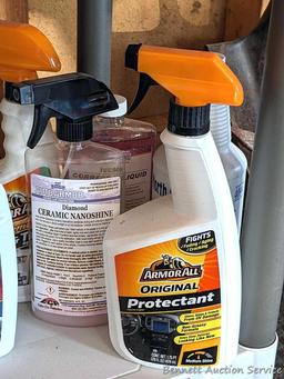 Full and partial bottles of automotive cleaners including leather cleaner, scratch out, tire white,